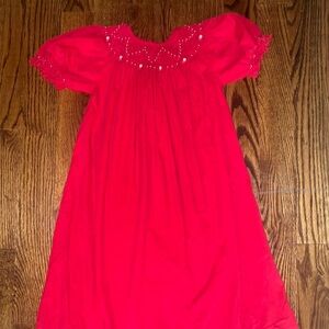 Girls red corduroy smocked dress with pearl accents and ruffle sleeves. Size 7